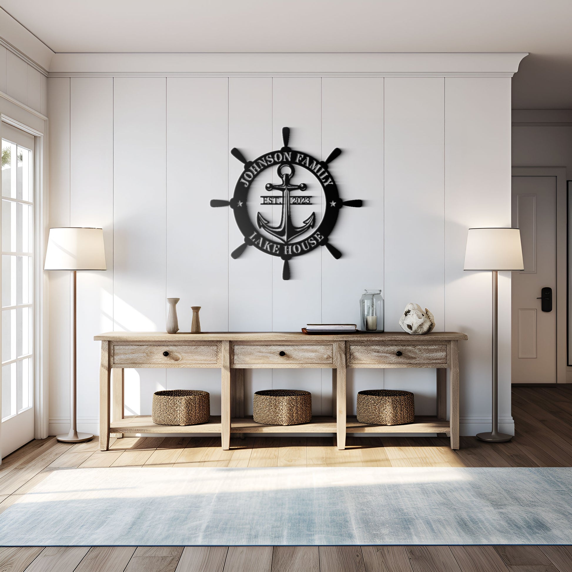 Nautical-themed wall decor with an anchor and wheel design above a wooden console table in a room with white walls and wooden flooring.